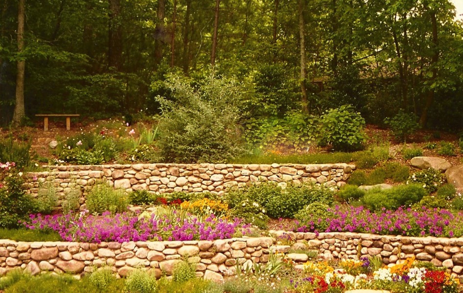 River rock stone wall terraces perennials